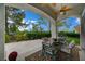 Outdoor patio with ceiling fan, dining set, and manicured greenery at 729 Sir James Bridge Way, Las Vegas, NV 89145