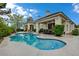 Beautiful pool area featuring a waterfall and covered patio with dining at 729 Sir James Bridge Way, Las Vegas, NV 89145