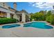 Backyard view with a freeform pool, spa, and covered patio with dining at 729 Sir James Bridge Way, Las Vegas, NV 89145