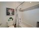 Shower/bath combo featuring white subway tile, shower curtain, unique artwork, and white toilet at 729 Sir James Bridge Way, Las Vegas, NV 89145