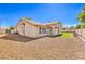 An inviting backyard featuring gravel landscaping, an artificial turf area, and a covered patio at 7410 Bridlehorne Ave, Las Vegas, NV 89131