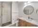 Modern bathroom with marble countertops, updated vanity, and a tiled walk-in shower at 7410 Bridlehorne Ave, Las Vegas, NV 89131