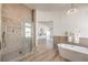 Elegant bathroom with modern glass shower, soaking tub, and tile flooring throughout at 7410 Bridlehorne Ave, Las Vegas, NV 89131