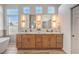 Bright bathroom featuring double sinks, modern fixtures, a soaking tub, and ample natural light at 7410 Bridlehorne Ave, Las Vegas, NV 89131