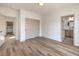 Cozy bedroom features wood-look floors and access to both a closet and ensuite bathroom at 7410 Bridlehorne Ave, Las Vegas, NV 89131