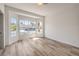 This bedroom with wood-look floors features a large bay window, providing plenty of natural light at 7410 Bridlehorne Ave, Las Vegas, NV 89131