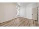 Bright bedroom with wood-look floors, white walls, and a large window, perfect for a guest room at 7410 Bridlehorne Ave, Las Vegas, NV 89131