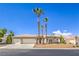 Charming single-story home featuring desert landscaping, palm trees and a two-car garage at 7410 Bridlehorne Ave, Las Vegas, NV 89131