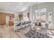 Bright, open kitchen with breakfast bar, modern countertops, and dining area filled with natural light at 7410 Bridlehorne Ave, Las Vegas, NV 89131