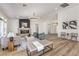 Bright, open living room with modern fireplace, stylish furniture, and hardwood floors at 7410 Bridlehorne Ave, Las Vegas, NV 89131