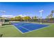 A well-maintained community tennis court ready for a match under the bright blue sky at 7410 Bridlehorne Ave, Las Vegas, NV 89131