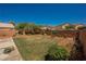 Expansive backyard with a well-maintained lawn and privacy fence for outdoor enjoyment at 7690 Morning Lake Dr, Las Vegas, NV 89131