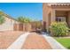 Gated Driveway featuring desert landscaping with neutral stone and stone walkways to a two story house at 7690 Morning Lake Dr, Las Vegas, NV 89131