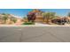 Two-story home featuring a manicured lawn, desert landscaping, and a neutral-toned exterior at 7690 Morning Lake Dr, Las Vegas, NV 89131