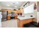Updated kitchen features stainless steel appliances, a stylish countertop, and a convenient breakfast bar for casual dining at 7690 Morning Lake Dr, Las Vegas, NV 89131