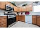 Updated kitchen featuring stainless steel appliances, wooden cabinetry, and ample counter space at 7690 Morning Lake Dr, Las Vegas, NV 89131
