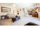 Inviting living room features tile floors, a cozy seating area, and easy access to the kitchen, perfect for entertaining at 7690 Morning Lake Dr, Las Vegas, NV 89131