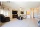 Comfortable living room showcases tile flooring, a ceiling fan, a fireplace and plenty of seating space at 7690 Morning Lake Dr, Las Vegas, NV 89131