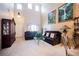 Bright living room boasts high ceilings, large windows, and comfortable seating, perfect for relaxing or entertaining guests at 7690 Morning Lake Dr, Las Vegas, NV 89131