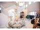 Open-concept living space featuring a staircase, chandelier, and comfortable seating area, ideal for modern living at 7690 Morning Lake Dr, Las Vegas, NV 89131