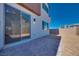 A private backyard features a sliding glass door, gravel landscaping, and block wall at 9756 Rock Cliff St, Las Vegas, NV 89141
