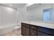 Bright bathroom featuring a tub with subway tile surround, dark cabinets, and white countertops at 9756 Rock Cliff St, Las Vegas, NV 89141