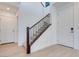 Bright entryway with a staircase featuring dark wood trim and white walls at 9756 Rock Cliff St, Las Vegas, NV 89141