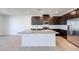 Kitchen with an island, stainless steel appliances, wood cabinets, and recessed lighting at 9756 Rock Cliff St, Las Vegas, NV 89141