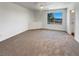 Bright bonus room with neutral carpet and a large window offering neighborhood views at 983 Plantain Lily Ave, Las Vegas, NV 89183