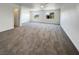 The oversized bonus room features neutral carpet, natural light, and a ceiling fan at 983 Plantain Lily Ave, Las Vegas, NV 89183