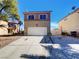 Charming home featuring a two-car garage, classic architectural details, and well-maintained landscaping at 983 Plantain Lily Ave, Las Vegas, NV 89183