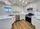 Modern kitchen with white cabinets, stainless steel appliances, and a quartz countertop at 983 Plantain Lily Ave, Las Vegas, NV 89183