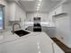 Modern kitchen featuring white cabinets, stainless steel appliances, quartz countertops, and a large island at 983 Plantain Lily Ave, Las Vegas, NV 89183