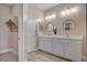 This bathroom has double sinks, framed mirrors, a linen closet, and a walk-in closet at 9903 Spinel Pl, Las Vegas, NV 89143