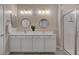 A spacious bathroom features double sinks, framed mirrors, and a glass-enclosed shower at 9903 Spinel Pl, Las Vegas, NV 89143