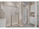 This is a nice bathroom with a big shower, tile, and white storage cabinets at 9903 Spinel Pl, Las Vegas, NV 89143
