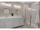 This bathroom has double sinks, framed mirrors, and a glass-enclosed shower at 9903 Spinel Pl, Las Vegas, NV 89143