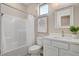 Well-lit bathroom featuring a shower-tub combo, white vanity, and framed mirror for a fresh, clean look at 9903 Spinel Pl, Las Vegas, NV 89143