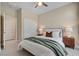 Comfortable bedroom featuring a ceiling fan, closet, and coordinating bedside tables and lamps at 9903 Spinel Pl, Las Vegas, NV 89143