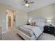 This is a neutral primary bedroom that has a ceiling fan and is carpeted at 9903 Spinel Pl, Las Vegas, NV 89143