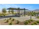 Inviting outdoor seating area with pergola and mountain views offering a relaxing community space at 9903 Spinel Pl, Las Vegas, NV 89143