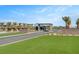 Inviting community entrance with lush landscaping, palm trees, and a modern security gate at 9903 Spinel Pl, Las Vegas, NV 89143