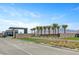 Beautiful gated community entrance featuring modern architecture and palm tree landscaping at 9903 Spinel Pl, Las Vegas, NV 89143