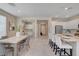 Open-concept layout of dining, kitchen, and office with modern finishes at 9903 Spinel Pl, Las Vegas, NV 89143