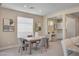 Cozy dining area with a modern table and chairs, complemented by elegant artwork and a built-in desk at 9903 Spinel Pl, Las Vegas, NV 89143