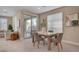 Cozy dining area with a view of the backyard, modern chairs, and plenty of natural light at 9903 Spinel Pl, Las Vegas, NV 89143