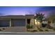 Charming single-story home with three-car garage, desert landscaping and tasteful stone accents at 9903 Spinel Pl, Las Vegas, NV 89143