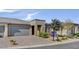 Charming single-story home with a neutral color scheme, desert landscaping, and a brick driveway at 9903 Spinel Pl, Las Vegas, NV 89143
