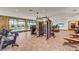 Bright gym featuring a range of cardio and strength training equipment with large windows for natural light at 9903 Spinel Pl, Las Vegas, NV 89143