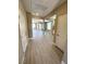 Hallway with light-colored flooring that leads to different rooms, offering a glimpse of the open-concept living space at 9903 Spinel Pl, Las Vegas, NV 89143